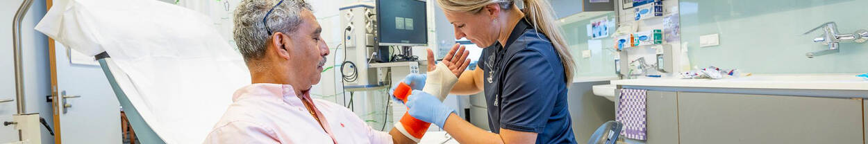 woman puts man's arm in cast